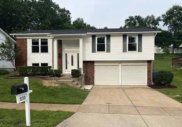 Front exterior of 930 Bellestri Dr with mailbox and two-car garage